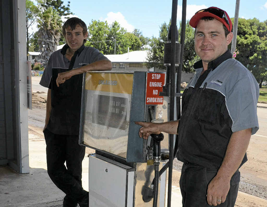 Cody Bartz and Paul Fox show where the water came up to in the 2013 January floods at the Killarney Autoworks Cody Bartz and Paul Fox show where the water came up to in the 2013 January floods at the Killarney Autoworks